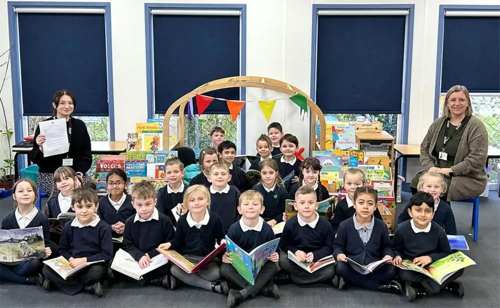 Megan Gosling, teacher, and Linette Pengelly, senior teaching assistant, along with the cohort of children who achieved results placing them in the top 5% of schools nationally