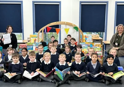 Megan Gosling, teacher, and Linette Pengelly, senior teaching assistant, along with the cohort of children who achieved results placing them in the top 5% of schools nationally