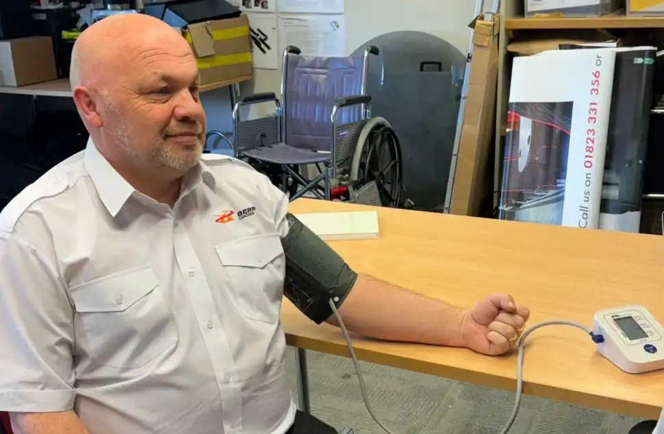 Alec Billen, courier manager at Berry's Coaches, has his blood pressure checked. Picture: Somerset Council