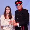 Ellie Bealing, being presented with her award by Ted Allen, Vice Lord-Lieutenant of Somerset. Picture: Moment Photography