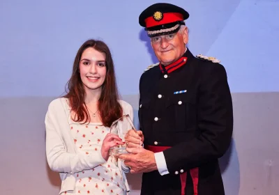 Ellie Bealing, being presented with her award by Ted Allen, Vice Lord-Lieutenant of Somerset. Picture: Moment Photography