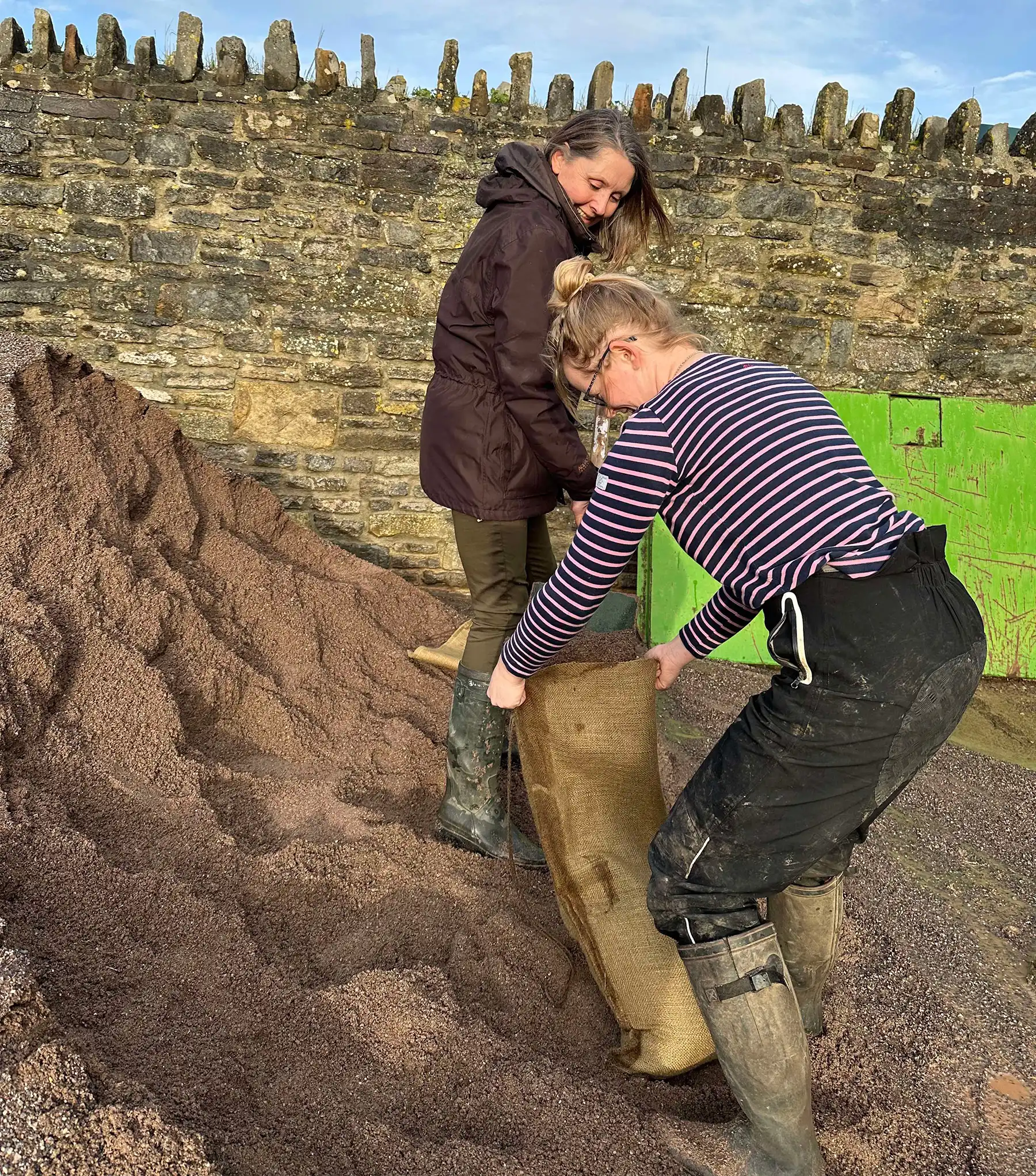 Staff and volunteers filling sandbags to protect the property from more flooding