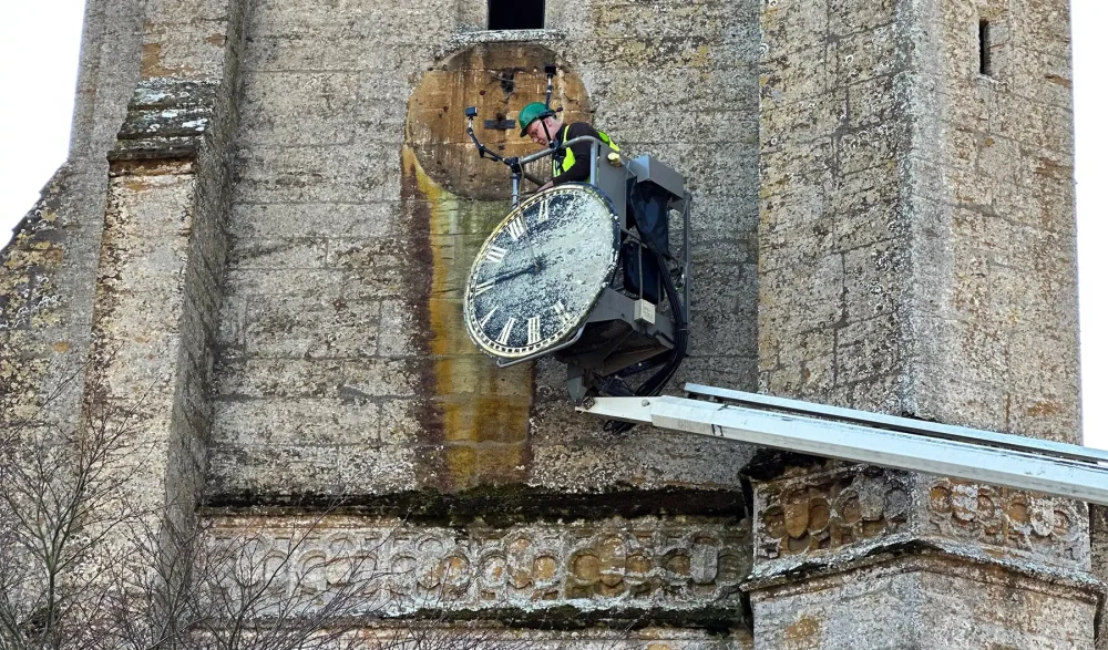 The clock face being taken down in Montacute
