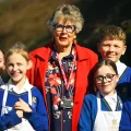 Dame Prue Leith DBE with Queen's College pupils