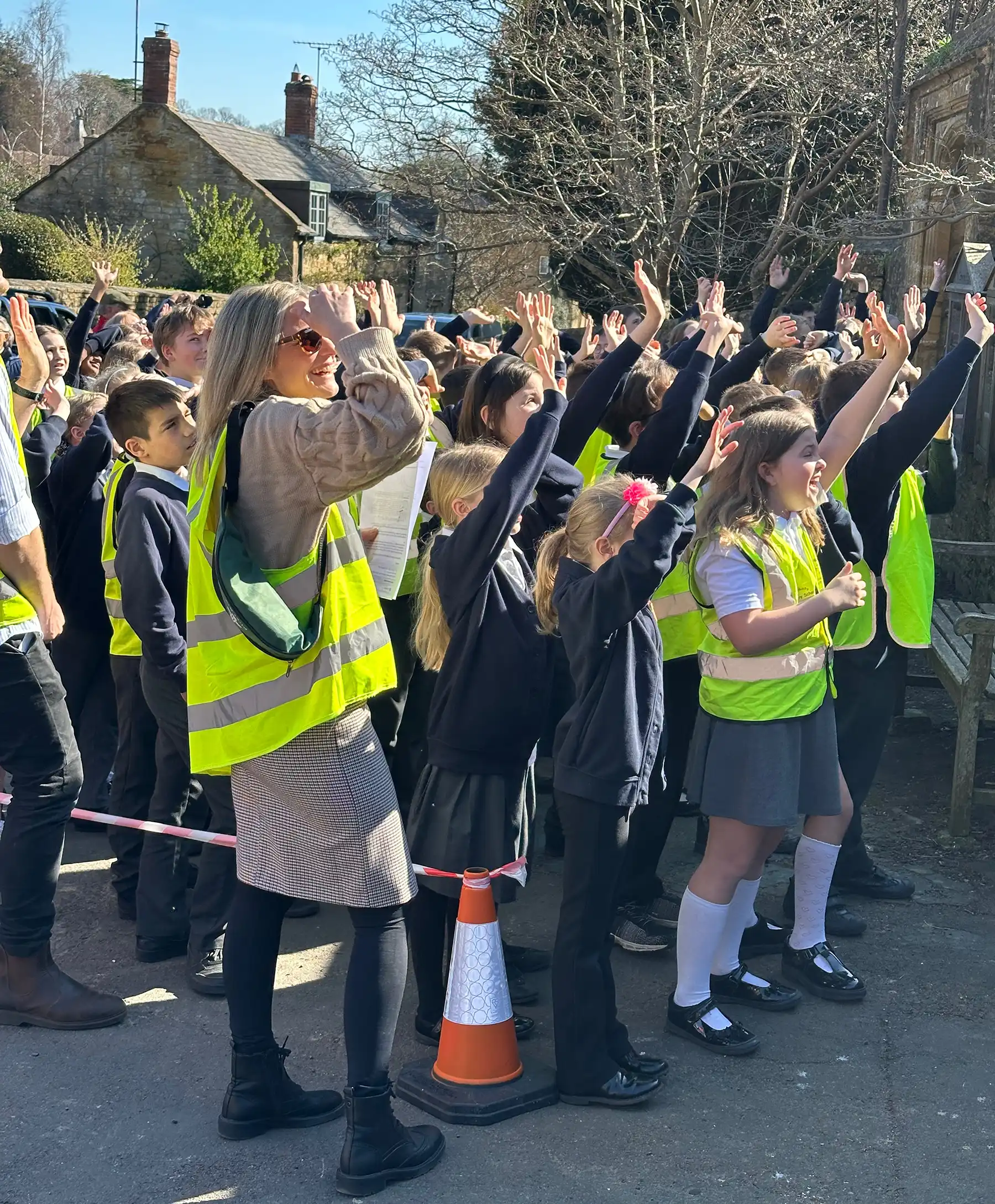 School children watch on as the clock face is removed