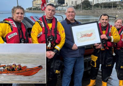 Malcom handing over his painting to Weston-super-Mare RNLI crew Picture: RNLI/Holly Turner