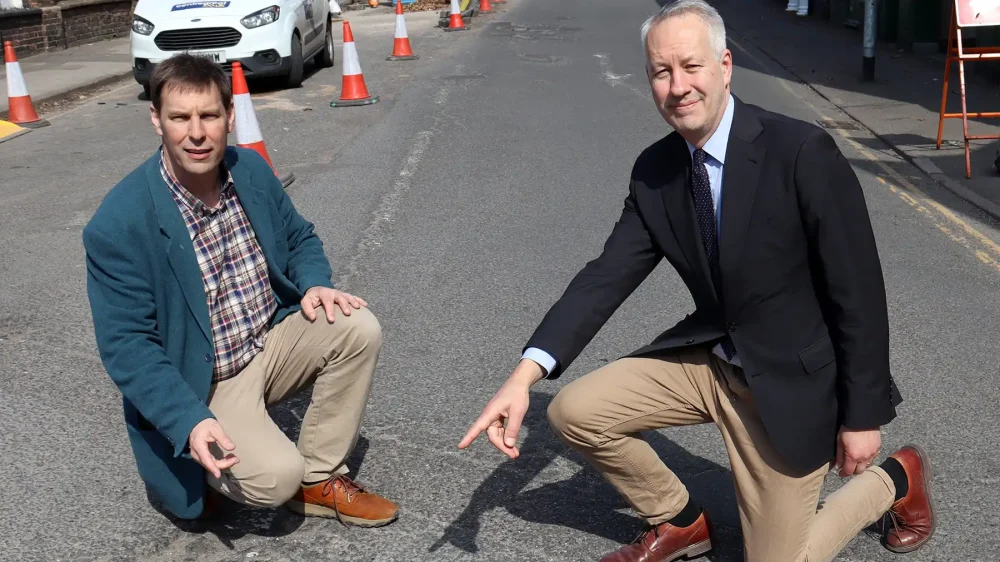 Cllr Wilkins and MP Gideon Amos pointing out potholes...