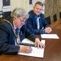 Chair of Somerset Council, Mike Best, signing the Memorandum of Understanding as Ukrainian Ambassador to the UK, Valerii Zaluzhnyi, looks on. Picture: Somerset Council