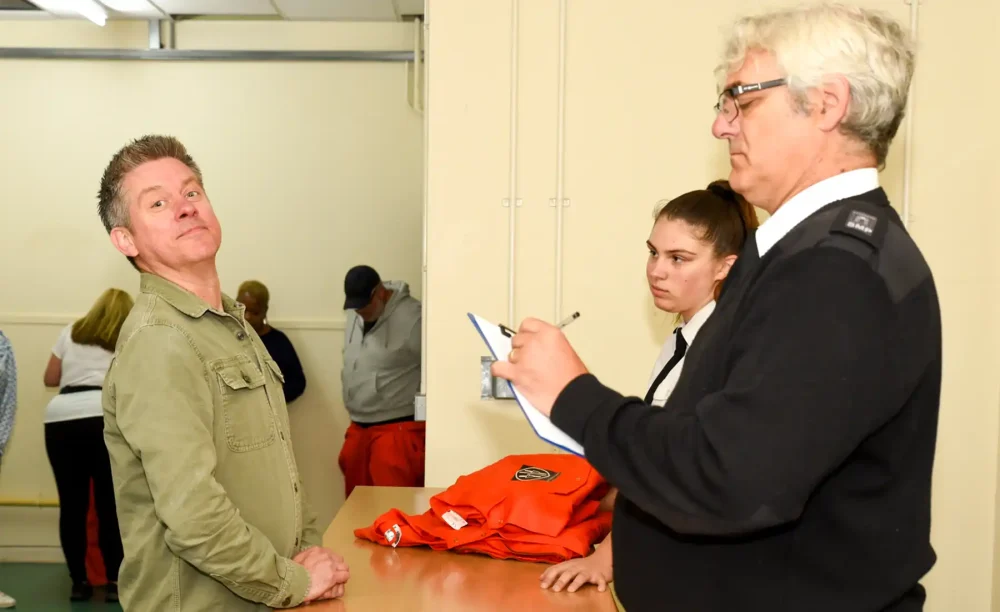 Richard McCourt - of Dick and Dom fame - fails to amuse the guards as he is booked in at Shepton Mallet Prison... Picture: Jon Gilbert Photography