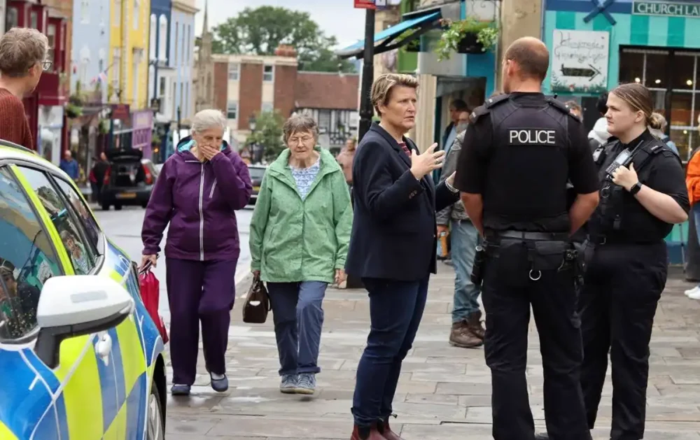 MP Sarah Dyke with police in Glastonbury High Street