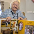 Barbara with a book featuring photos from her life