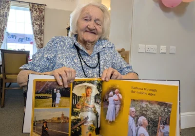 Barbara with a book featuring photos from her life