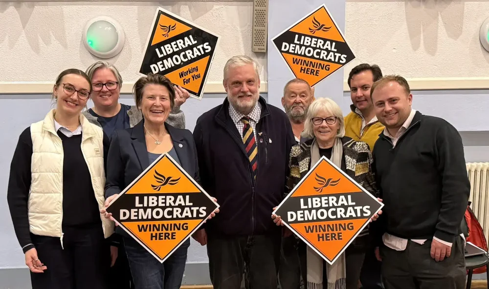Ewan Cameron, centre, flanked by Lib Dem campaigners, including MP Sarah Dyke, after the result was announced