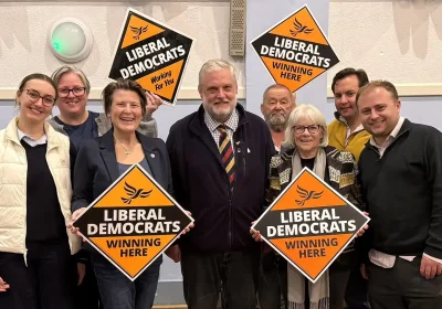 Ewan Cameron, centre, flanked by Lib Dem campaigners, including MP Sarah Dyke, after the result was announced