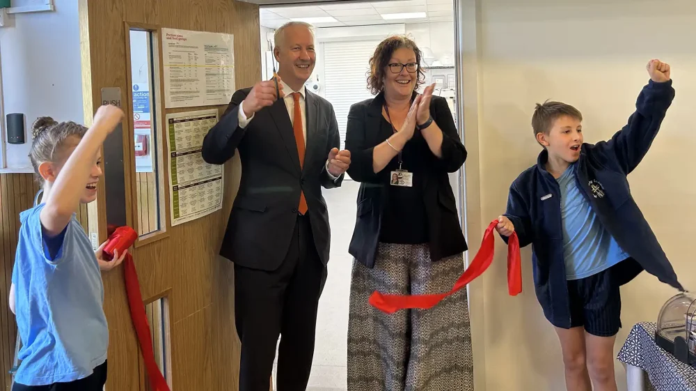 MP Gideon Amos cuts the ribbon to officially open the news kitchens