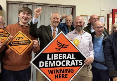 New Wellington councillor Gareth Williams and MP Gideon Amos celebrate with fellow Lib Dems
