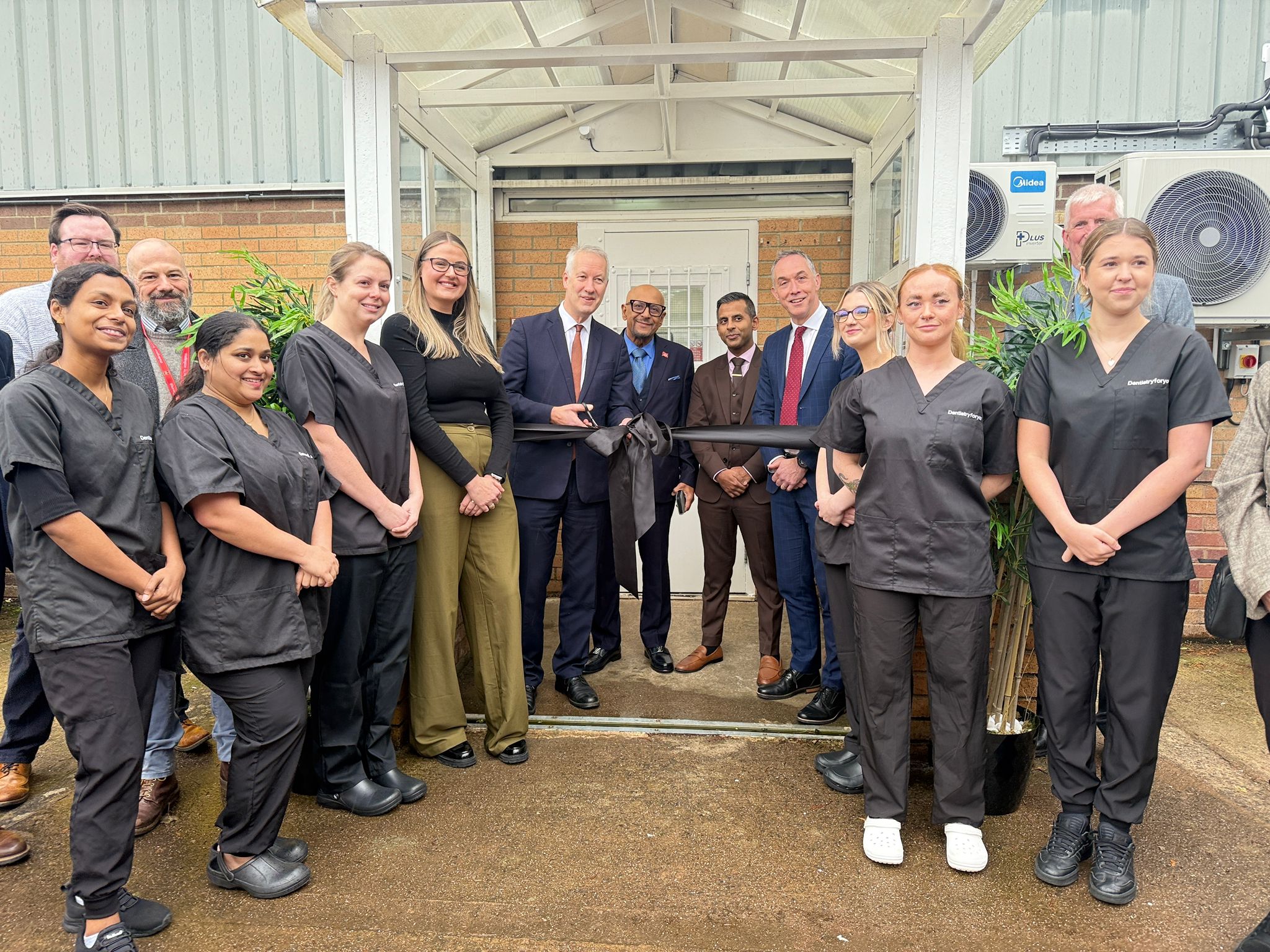 MP Gideon Amos cuts the ribbon at the new dentist in Wellington