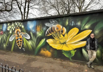 Artist Jody Thomas with his new mural in Frome. Picture: Frome Town Council