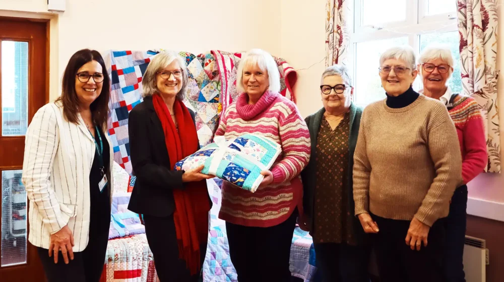 Members of the Polden Stichers donating the blankets to Somerset Council