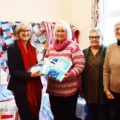 Members of the Polden Stichers donating the blankets to Somerset Council