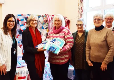 Members of the Polden Stichers donating the blankets to Somerset Council